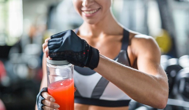 woman with shaker bottle in gym