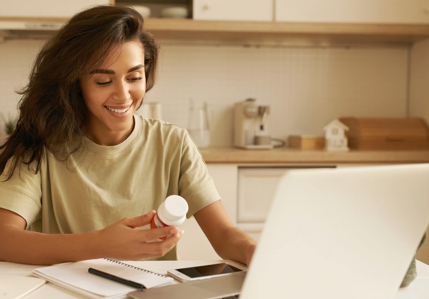 Woman looking at supplement bottle