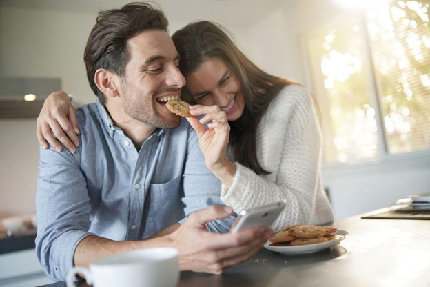 man and woman eating cookies