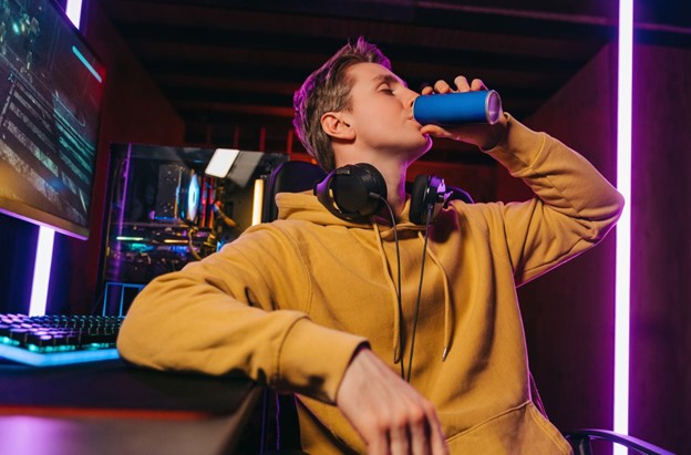 boy drinking energy drink while gaming