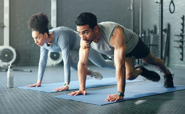 man and woman doing yoga