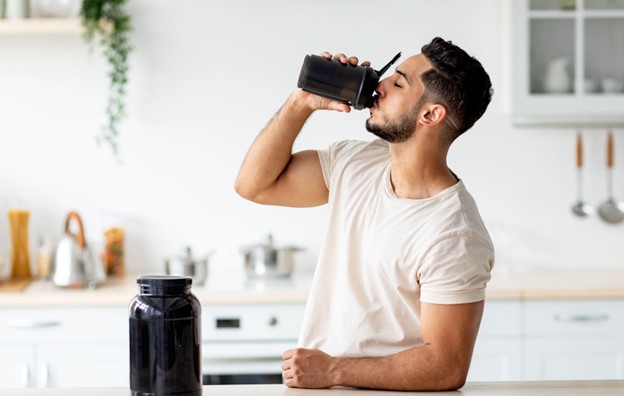 man drinking protein