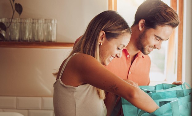 two people unpacking groceries