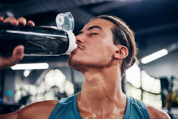 man drinking beverage