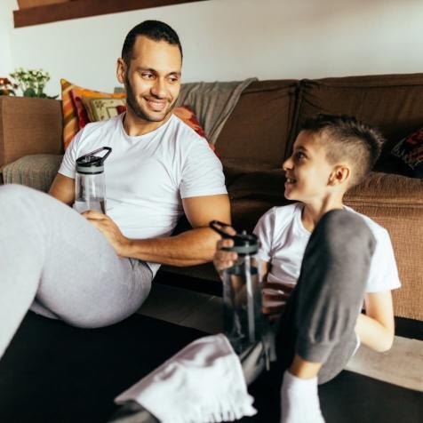 man and boy drinking water