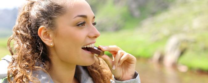 woman eating protein bar