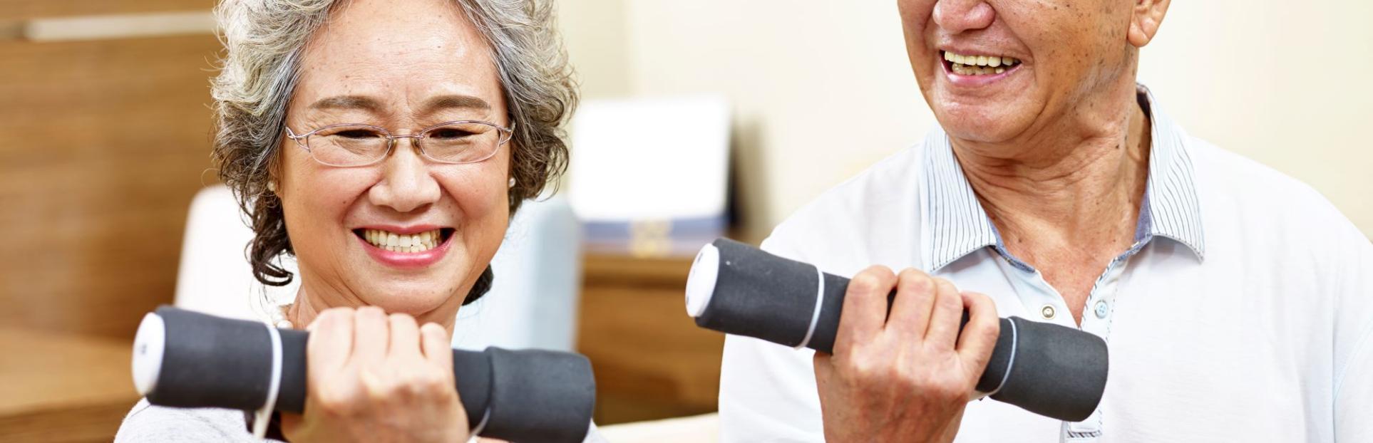 senior man and woman lifting weight