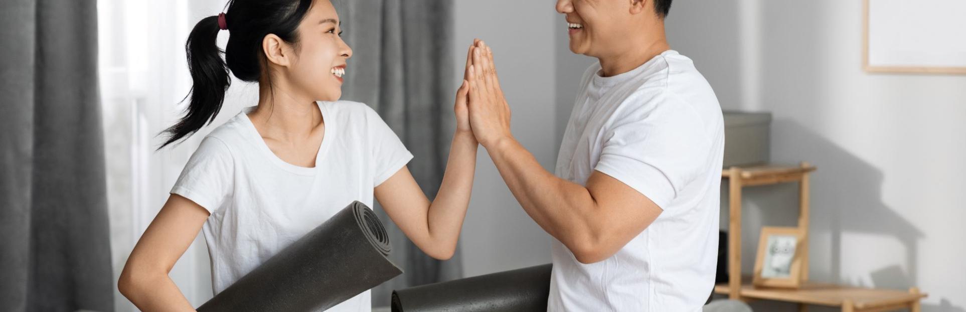 man and woman high fiving