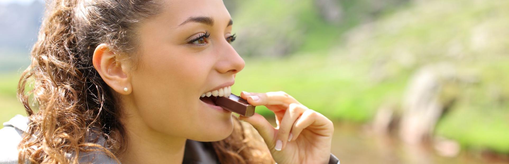 woman eating protein bar