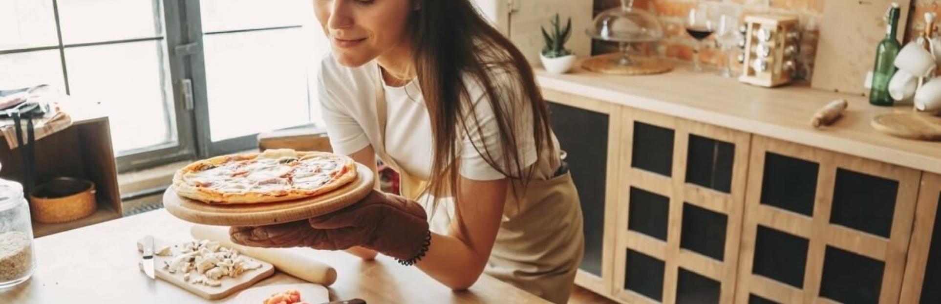 girl looking at pizza