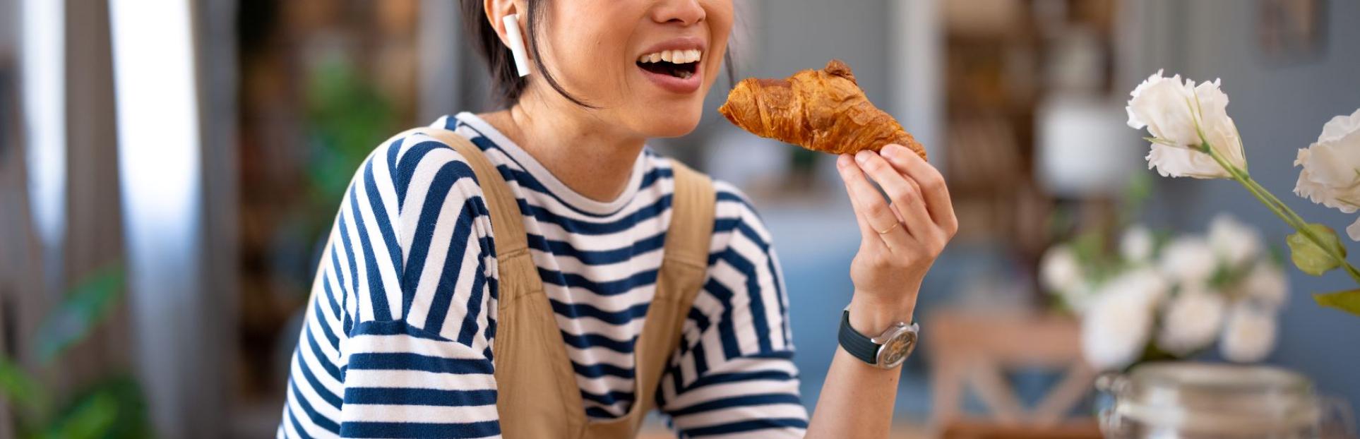 Woman eating bakery item