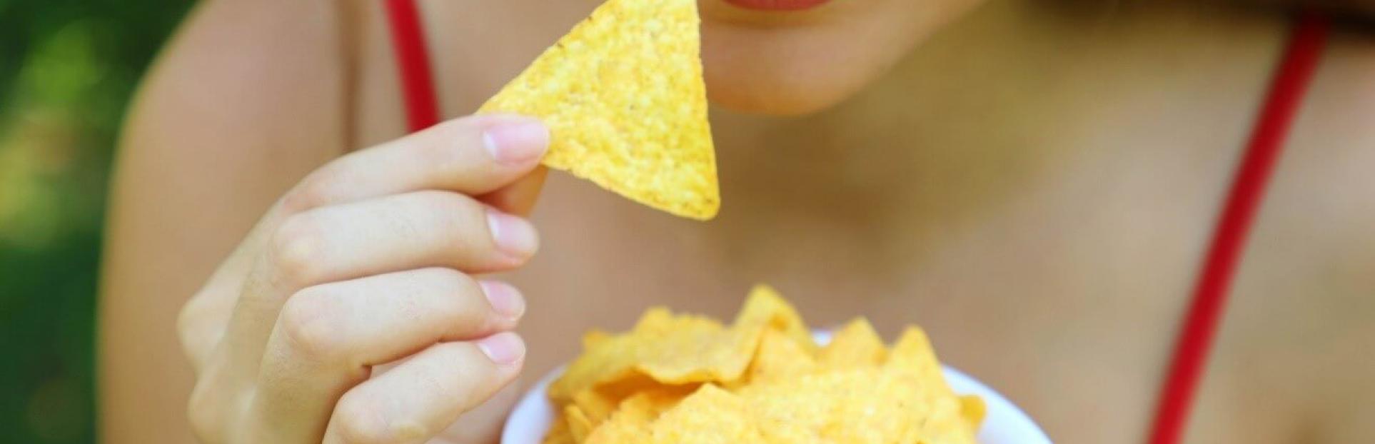 woman eating tortilla chips