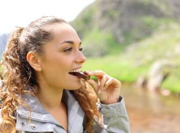 woman eating protein bar