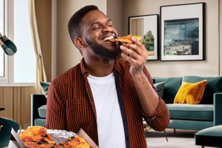 man eating pizza