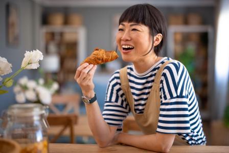 woman eating a croissant