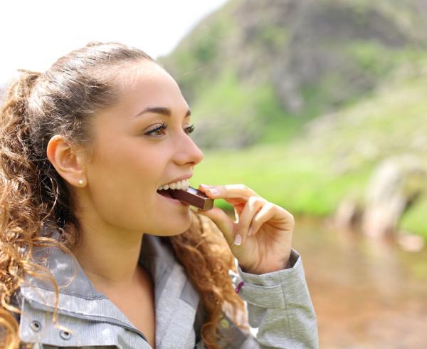 woman eating protein bar