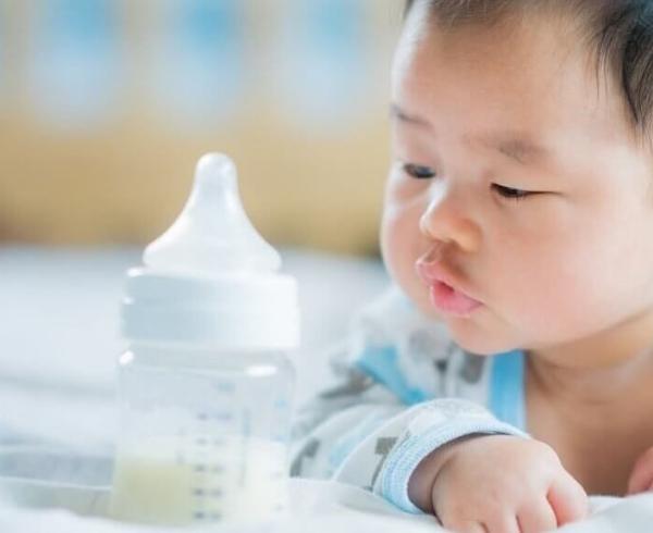 baby with bottle of milk