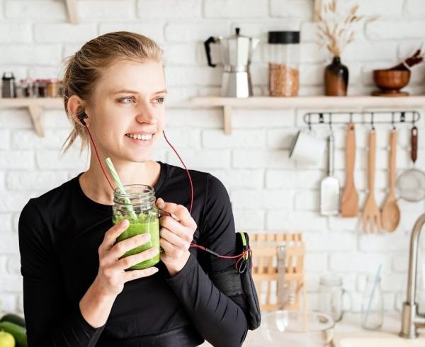 woman drinking green juice