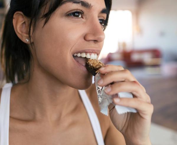 woman eating bar