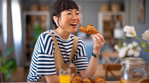 Woman eating bakery item